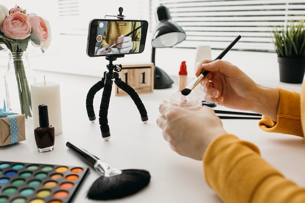 Free Photo female blogger streaming make-up online with smartphone