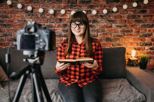 Female blogger streaming online with camera