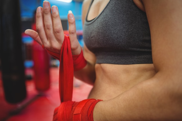 Female boxer wearing red strap on wrist