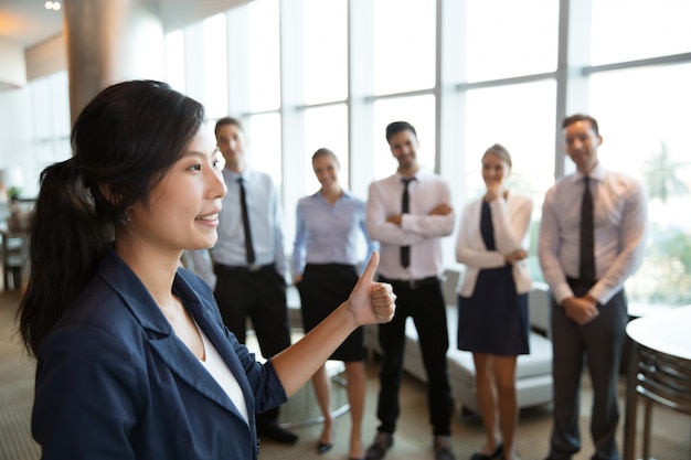 Free photo female business leader with thumb up