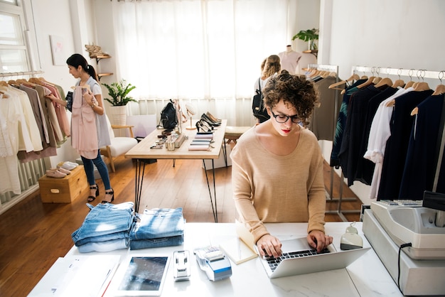 Free photo a female business owner is using the laptop