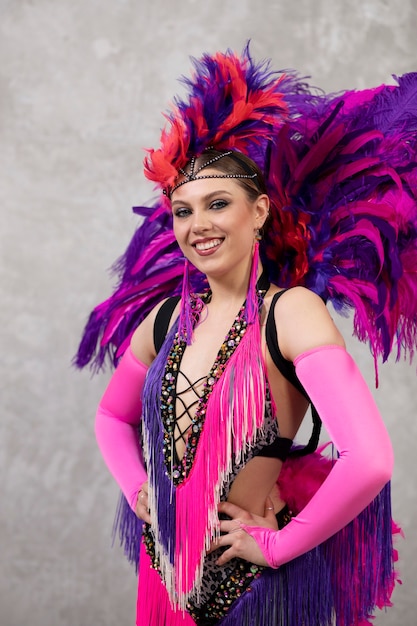 Female cabaret performer posing in feathers costume