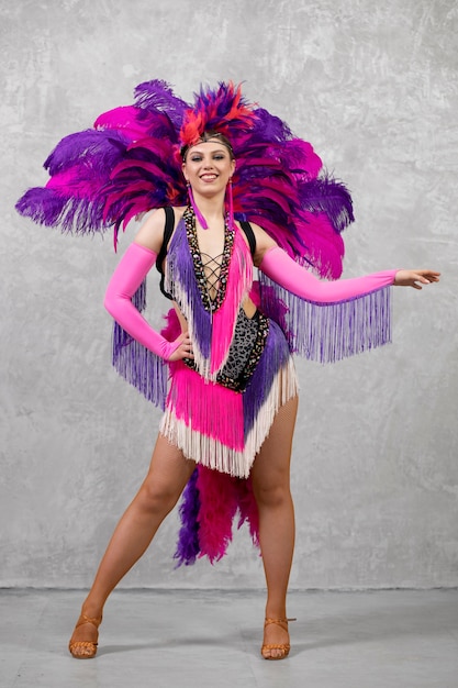 Free Photo female cabaret performer posing in feathers costume