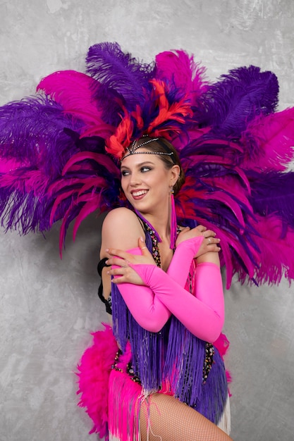 Female cabaret performer posing in feathers costume