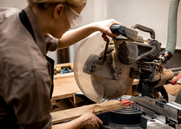 Female carpenter with glasses and tool