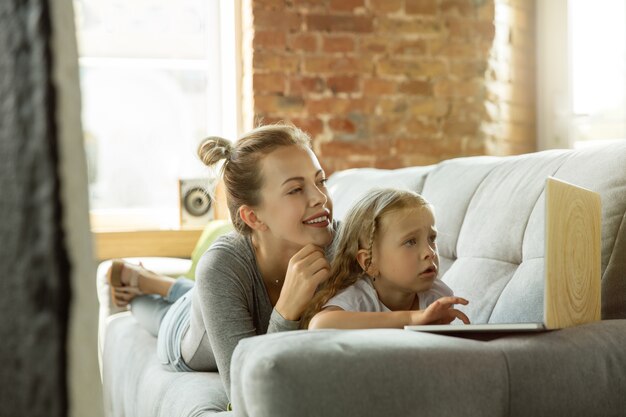 Female caucasian teacher and little girl, or mom and daughter.