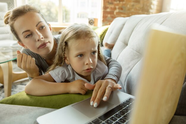 Female caucasian teacher and little girl, or mom and daughter.