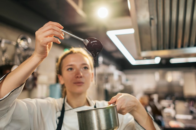 Free Photo female chef checking sauce