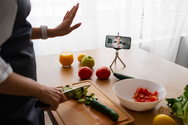 Free photo female chef having a videocall while cooking