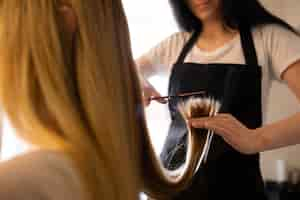 Free photo female client getting her hair cut at the hairdresser