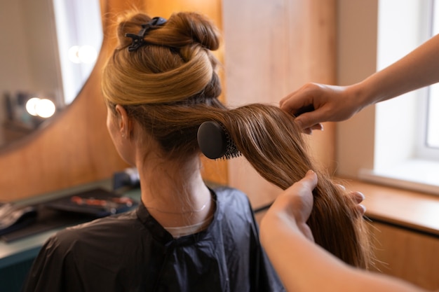 Free photo female client getting her hair done at the hairdresser