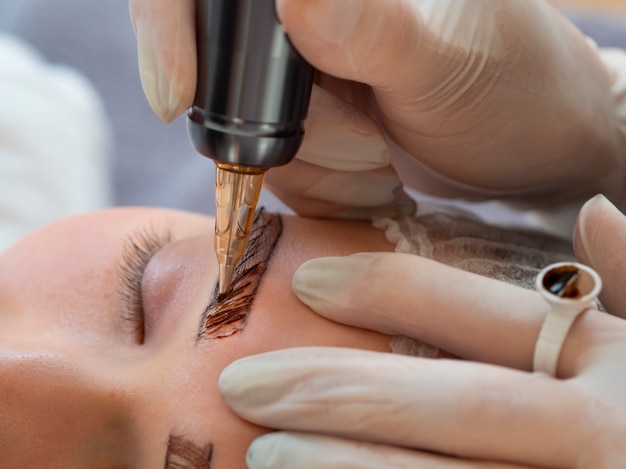 Free photo female client going through a microblading treatment