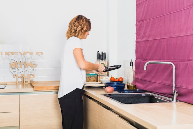 Free Photo female cooking in cozy kitchen