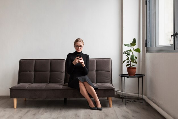 Female on couch using mobile