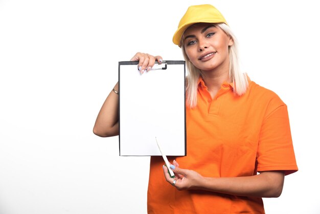 Female courier pointing at empty notebook on white background. High quality photo