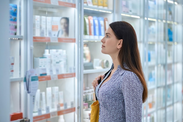 Free photo female customer choosing products in a drugstore