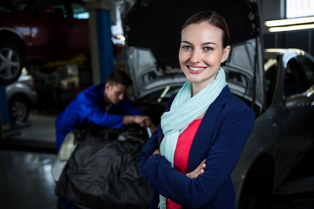 Female customer smiling with arms crossed