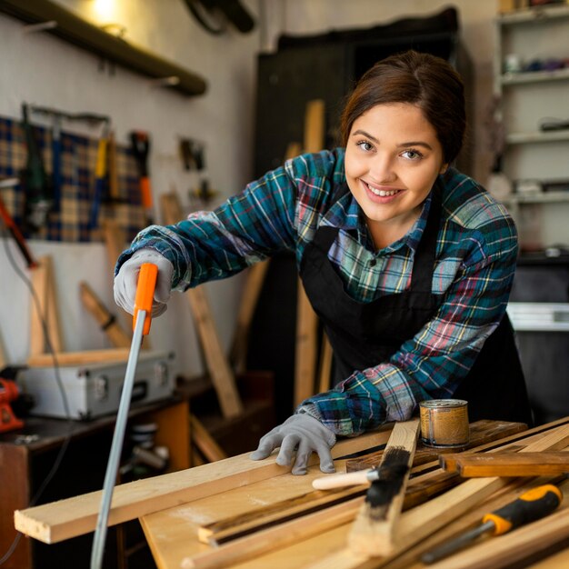 Female cutting a wood plank