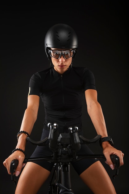 Free photo female cyclist posing with bicycle and helmet