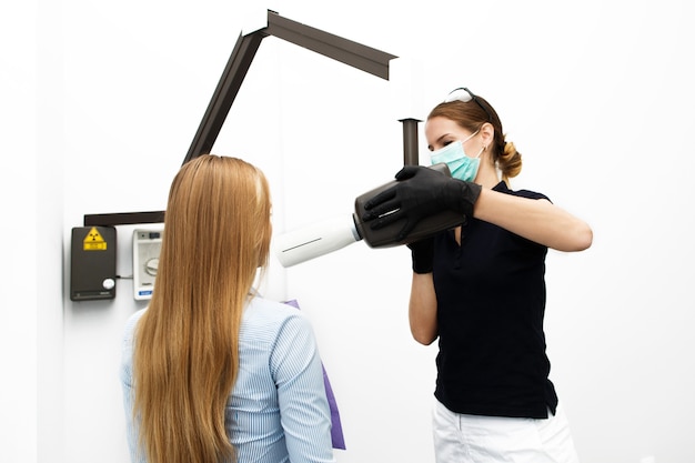 Female dentist is ready to scan woman's teeth