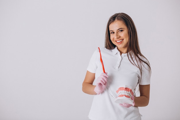 Female dentist with dentistry tools isolated