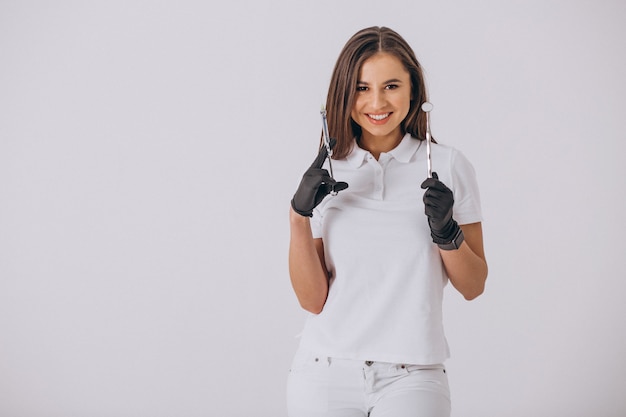 Female dentist with dentistry tools isolated