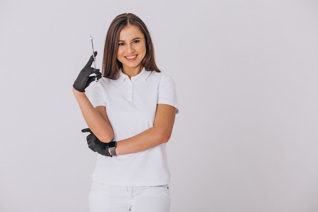 Female dentist with dentistry tools isolated