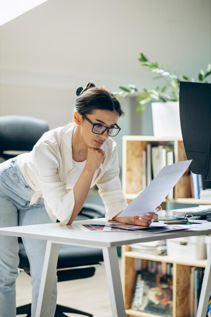 Female digital designer looking at swatches at an office