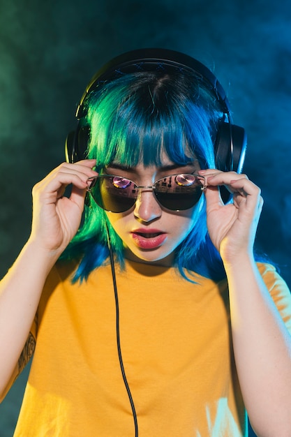 Female dj putting on sunglasses