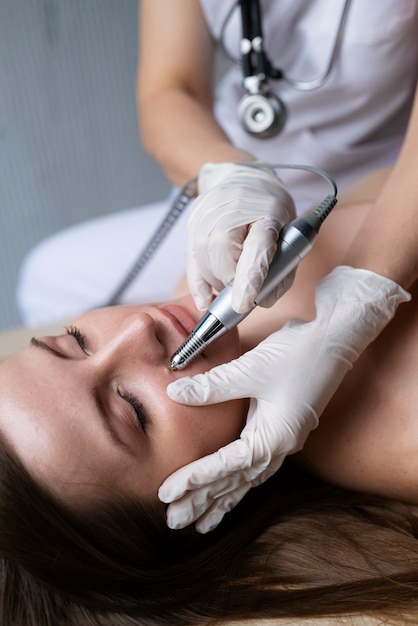 Female doctor diagnosing a melanoma on the body of a female patient