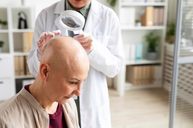 Female doctor doing a check on a patient with skin cancer