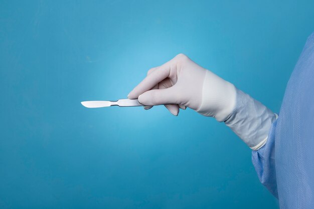 Female doctor holding metallic medical scalpel