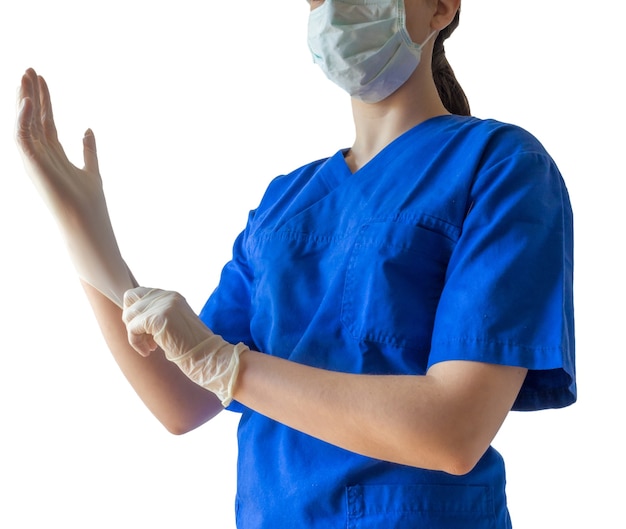 Free Photo female doctor in a medical uniform and mask putting on medical gloves getting ready for a surgery