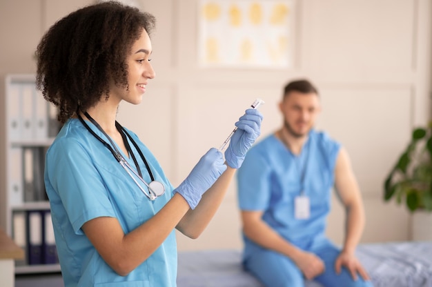 Female doctor preparing the vaccination for her colleague