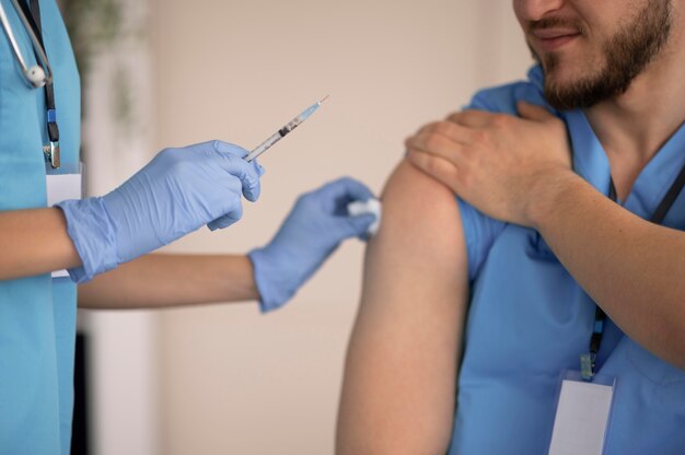 Female doctor preparing the vaccination for her colleague