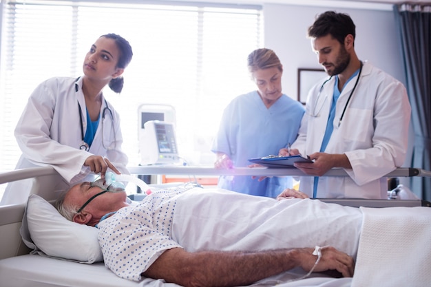 Female doctor putting oxygen mask on patient face