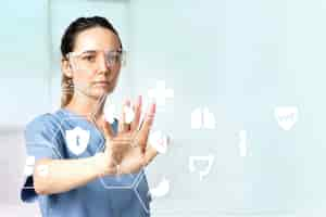 Free photo female doctor  with smart glasses touching virtual screen medical technology