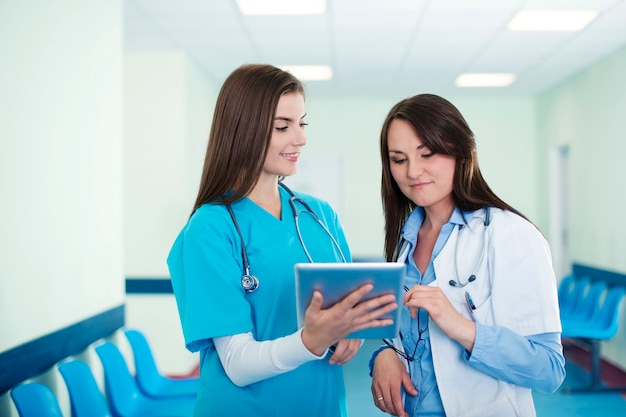 Female doctors checking results on digital tablet