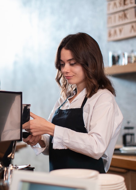 Female employee making coffee