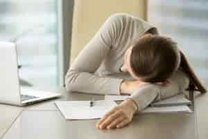 Free photo female employee slumbers at workplace in office