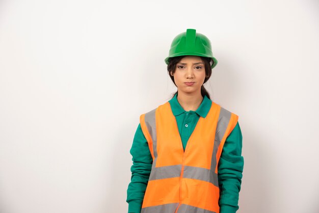 Female employee with upset face on white background.