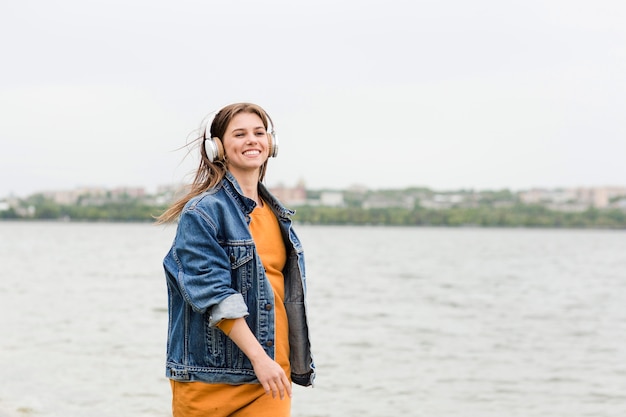 Female enjoying seaside and music