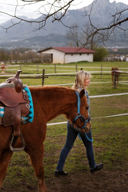 Female equestrian instructor with horse