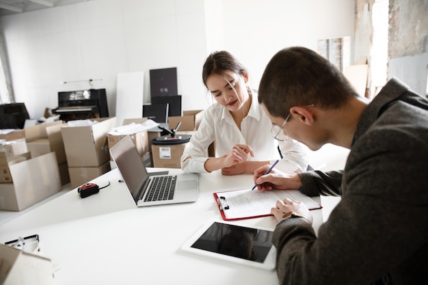 Female estate agent showing new home to a young man after a discussion on house plans, moving, new home concept