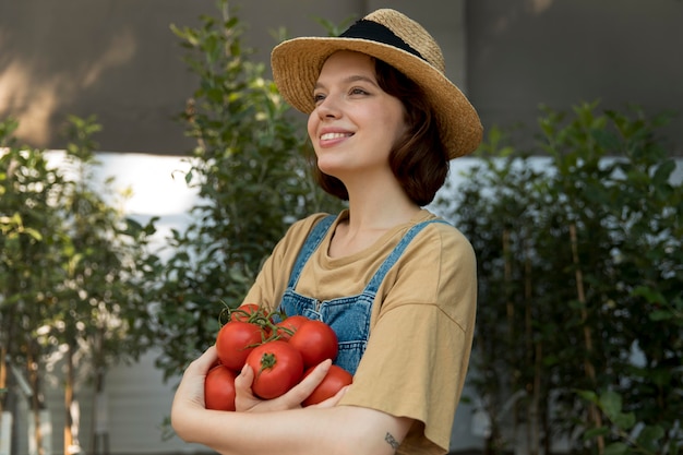 Female farmer holding some tomatoes