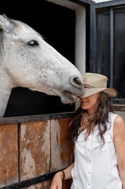 Female farmer with her horse at the ranch