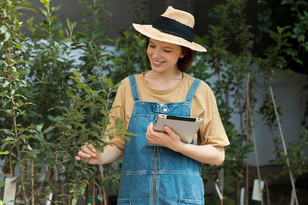 Female farmer working alone in her greenhouse