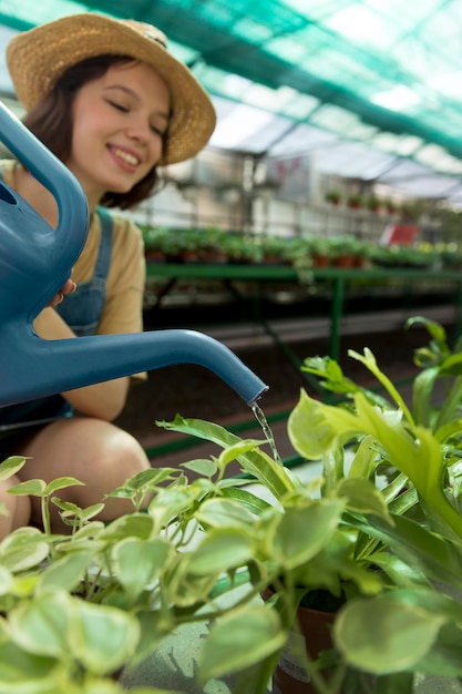 Free photo female farmer working in a greenhouse