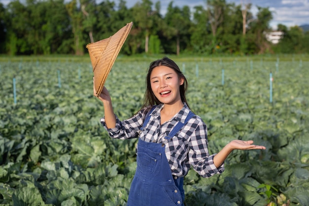 Female farmers who are happy with the crops in their gardens.