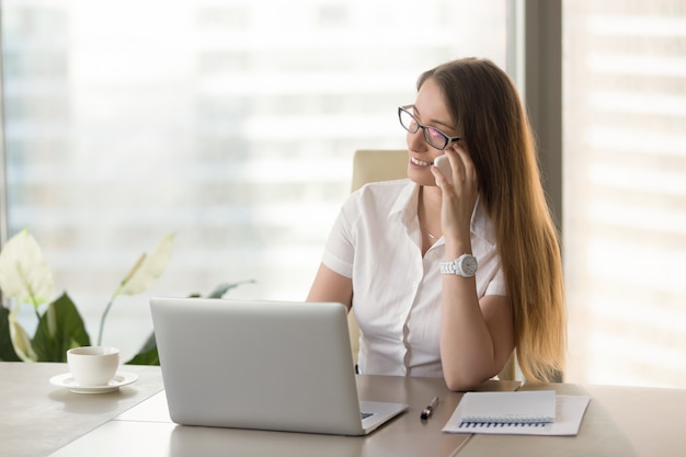 Female financial adviser consults clients by phone